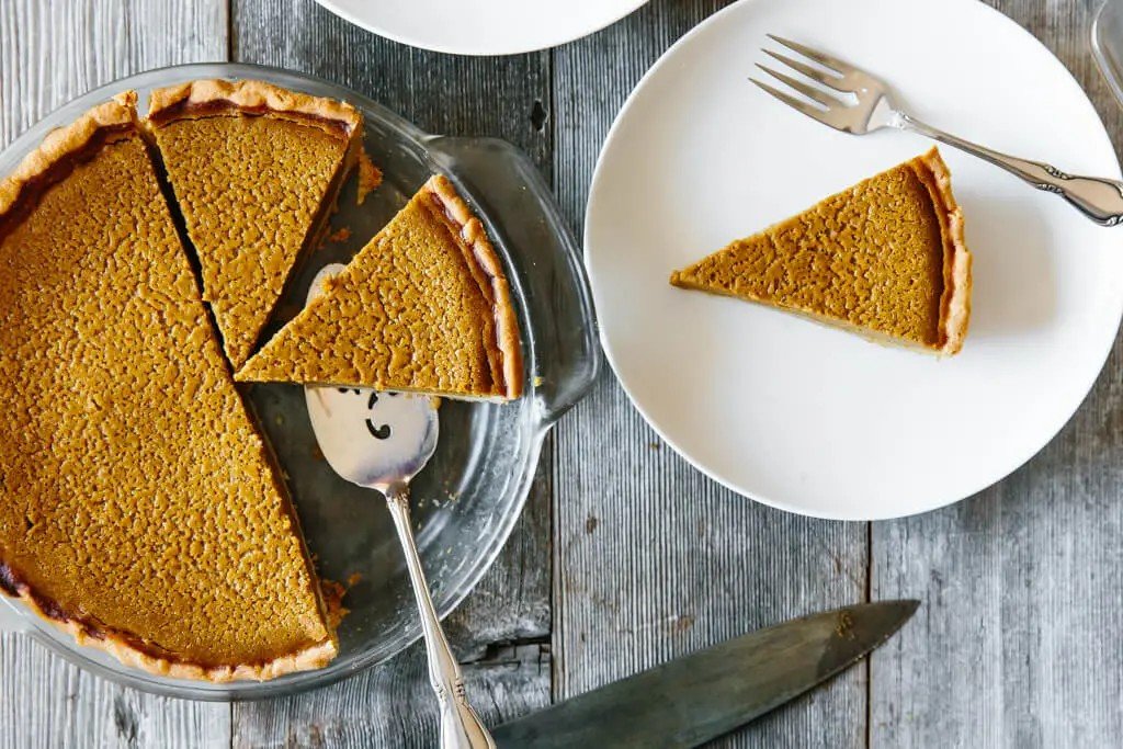 Slice of paleo pumpkin pie with an almond and cassava flour crust