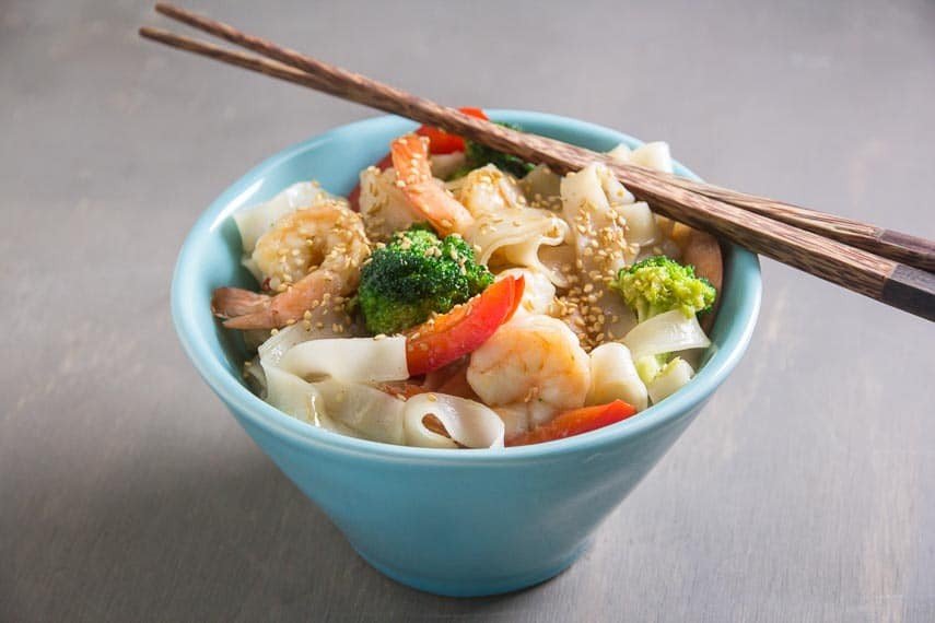 Bowl of low FODMAP shrimp and broccoli with rice noodles