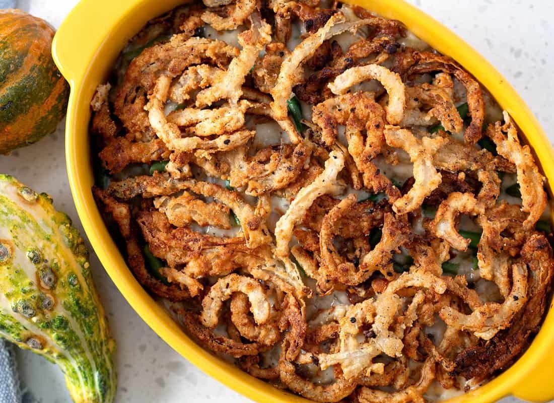 Paleo green bean casserole topped with crispy onions and bacon