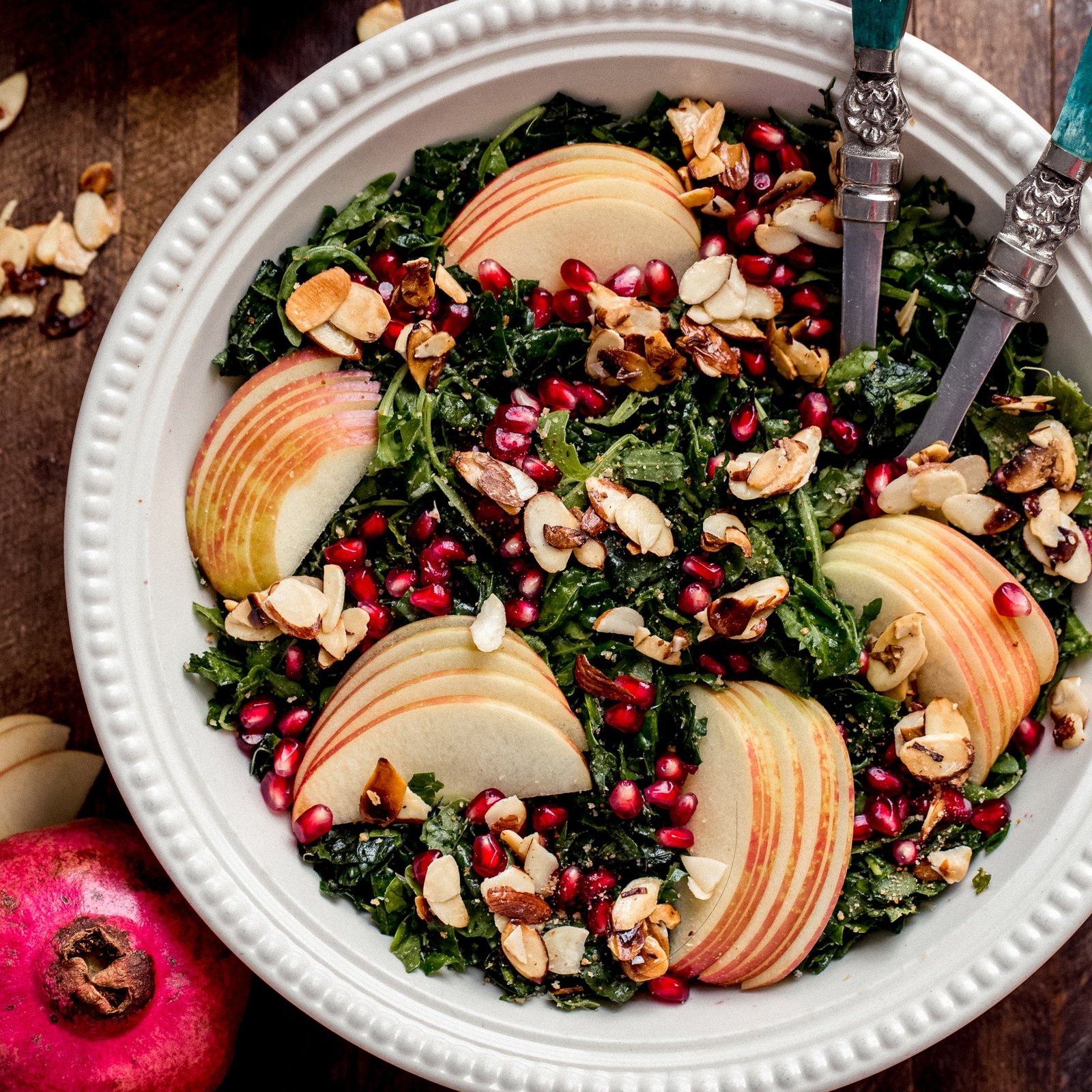 Autumn kale harvest salad with apple slices and pomegranate seeds